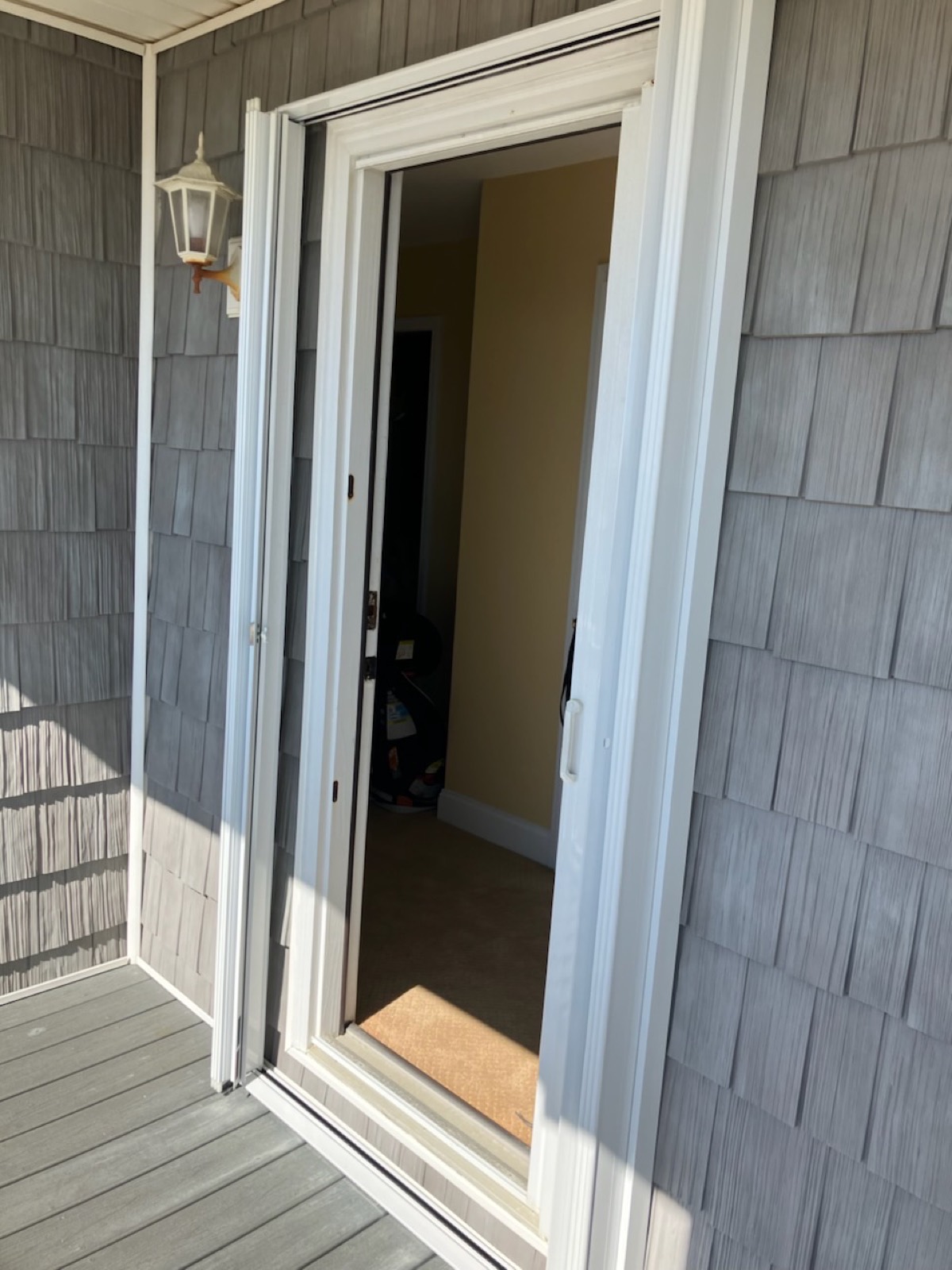 Accordion shutters folded beside a glass door on a beach house