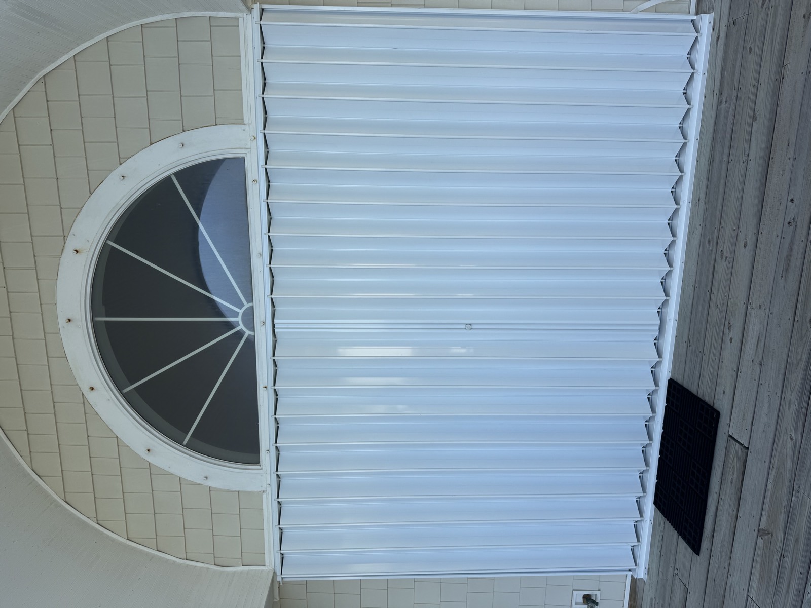 Accordion shutters on the doors of a coastal home