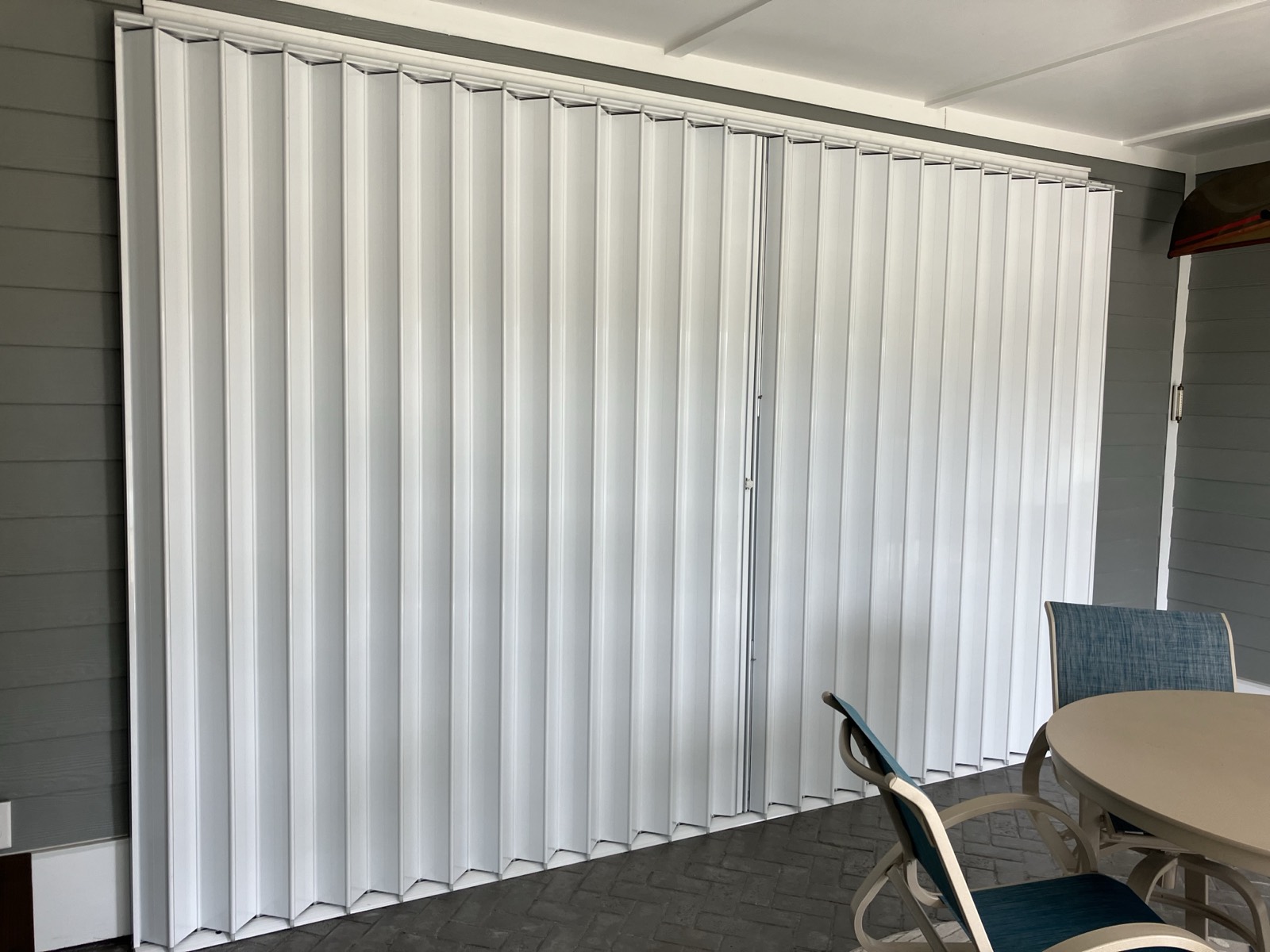 Accordion shutters protecting a beach house slider