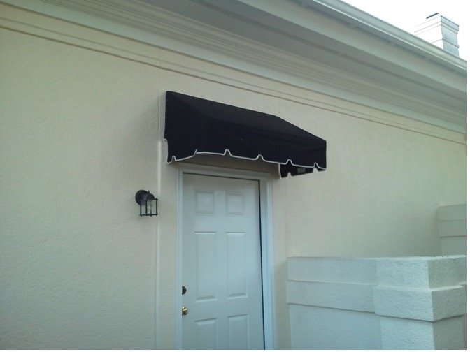 Solid color fabric awning over a residential entry
