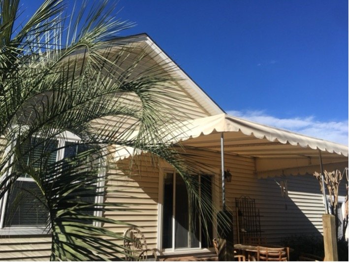 Striped fabric awning over a residential deck