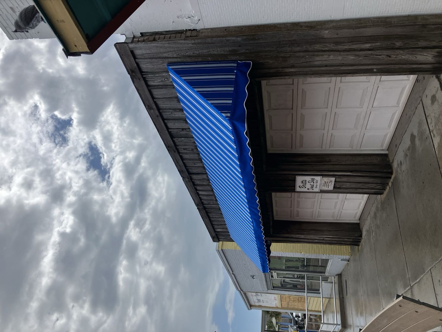 Iconic blue and white striped fabric awning at Britt's Donut Shop in Carolina Beach