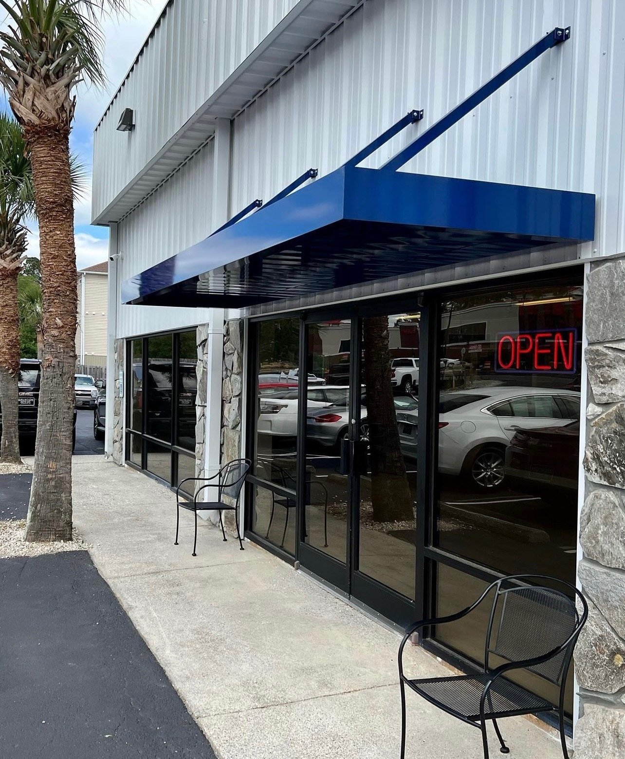 Architectural metal canopy installed on a coastal commercial building