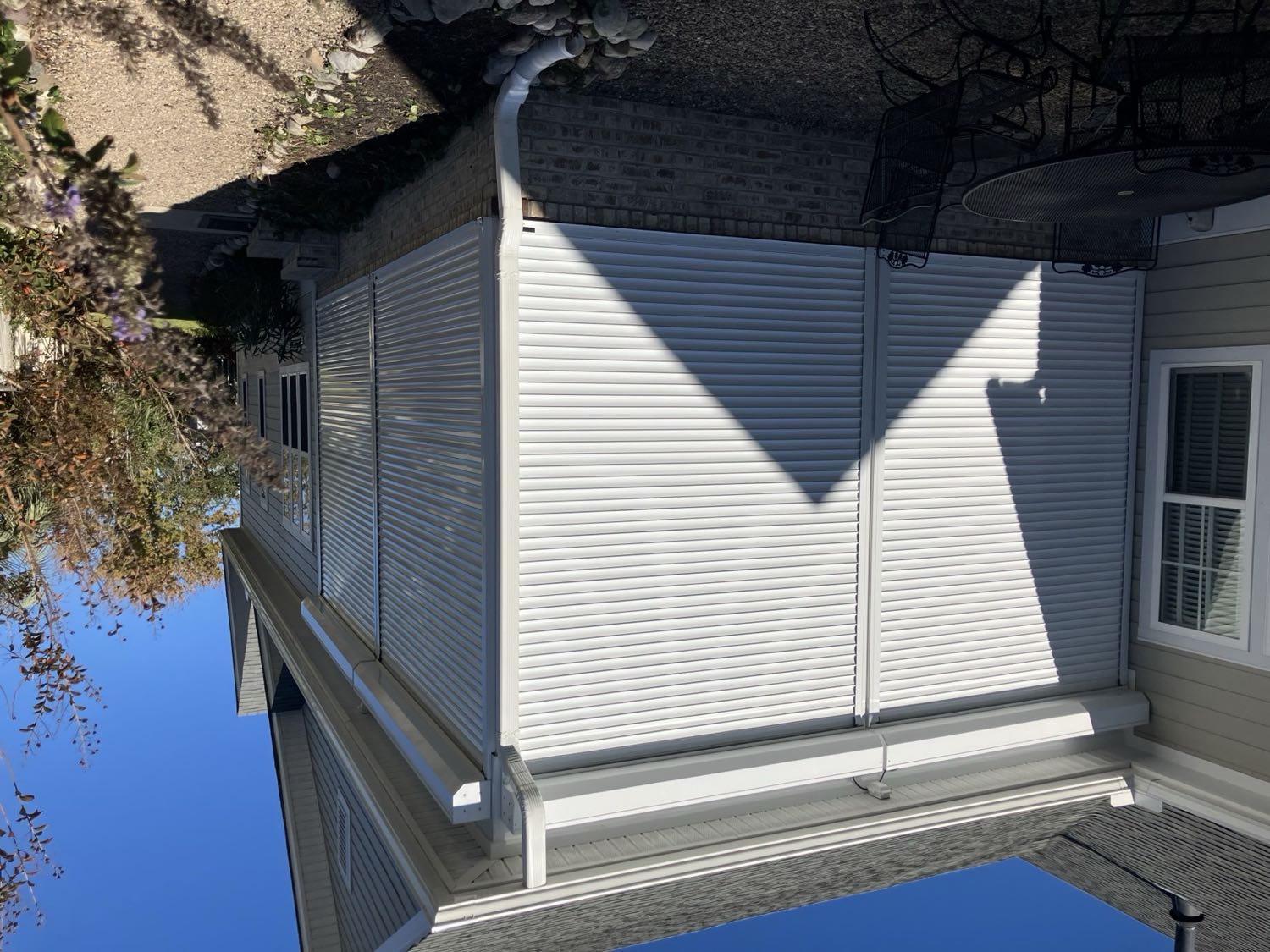 Motorized roll shutters on a coastal home near the beach