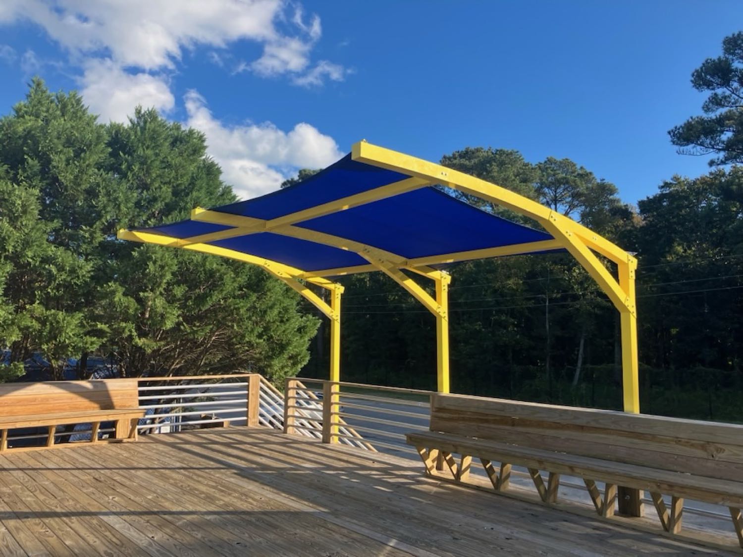 Custom shade sails over a waterfront deck