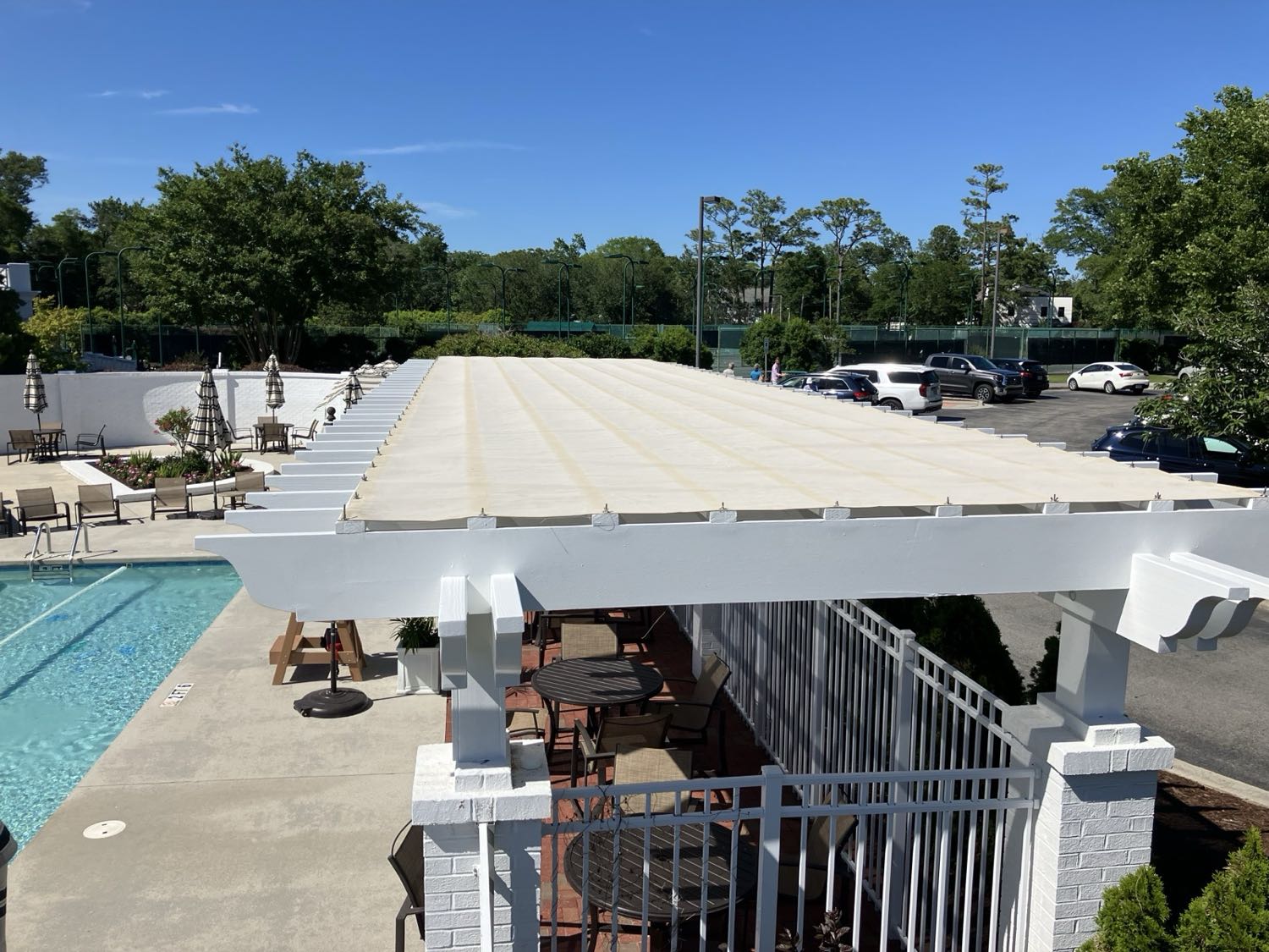 Custom fabric pergola shade cover over a poolside pergola