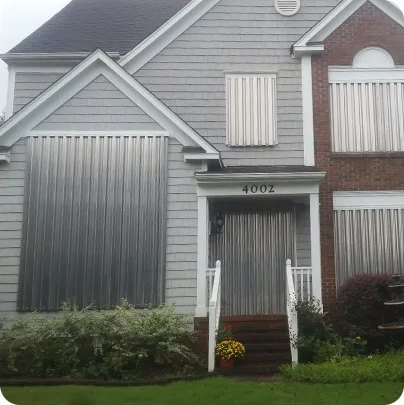 Aluminum storm panels covering the windows of a coastal home