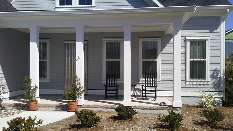 Aluminum storm panels installed over the windows of a home