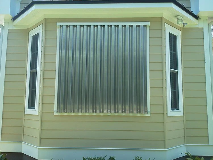 Aluminum storm panels ready for installation on a home