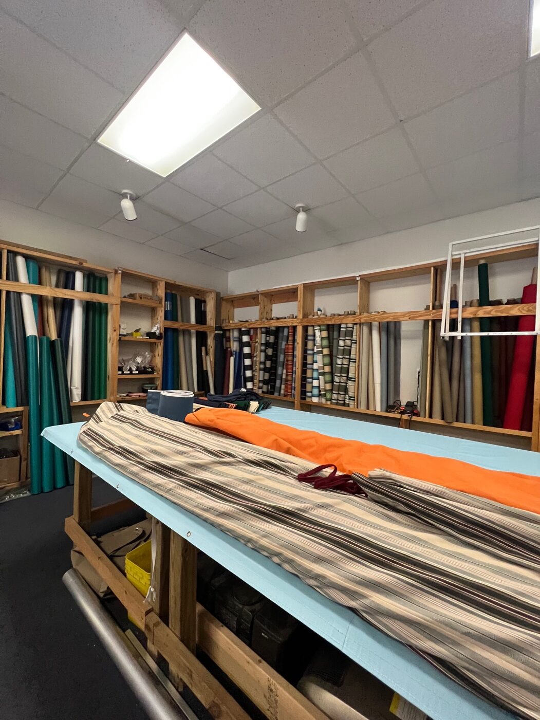 Textile shop with fabric rolls on shelves